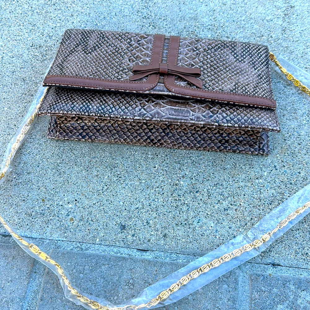 Faux snakeskin clutch with shoulder chain.  Never used
